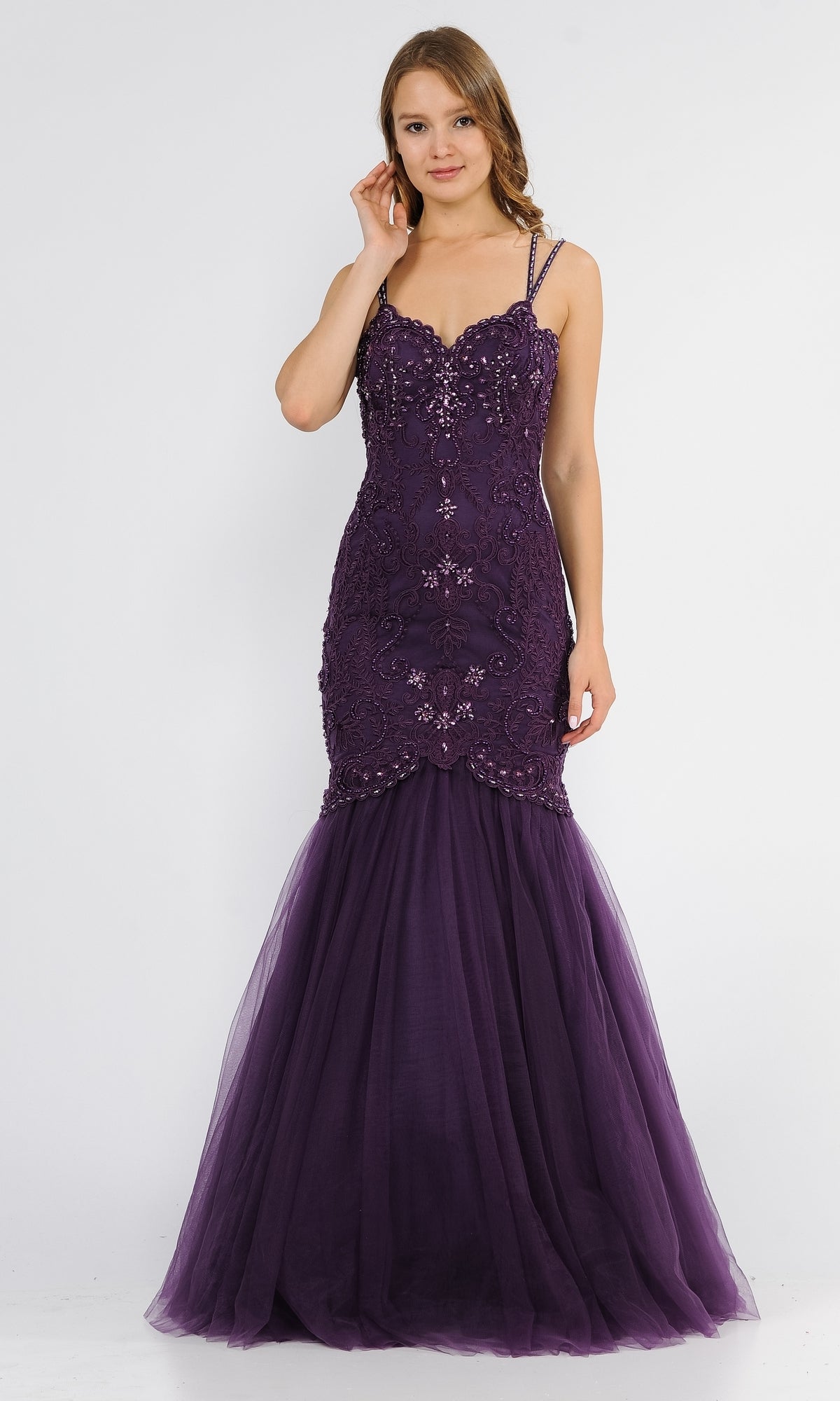 A woman stands against a plain white background wearing the Embroidered Tight Sweetheart Mermaid Prom Dress 8352, featuring dark purple beads, thin straps, and a mermaid silhouette.